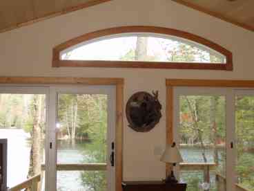Breathtaking views from this Great Room with double sliding glass doors, deck, and short walk to the dock and boat.