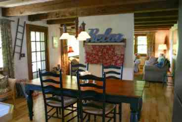 Dining area seats eight and two additional guests at the bar.