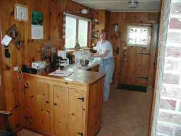 Galley-like kitchen has beachront view, ability to watch children playing on sand from the house