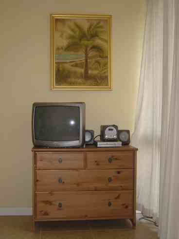 Living room TV, CD player and DVD.  Also a 4 drawer dresser for guests staying on the sofa bed.