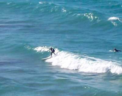 Actual photo of someone surfing in front of home.
