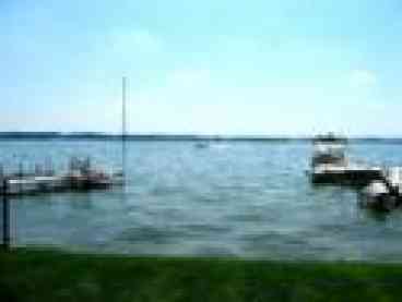 Part of a spectacular view of the lake as seen from the patio looking out and to the right of the pier....lovely blue skies and crystal clear water. A typical summer day on Lake Wawasee!
