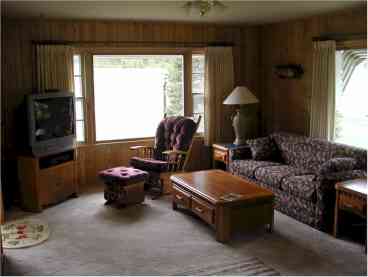 Located in the southwestern side of the house, the living room of Gold Dust has two large picture windows - one facing the pines to the south, and the other looking west toward the large meadow, where part of Custer's Expedition of 1872 camped and explored for gold.