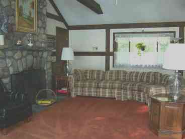 Beautiful great room with cathedral ceiling and stone fireplace.