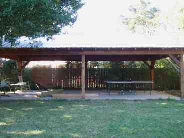 Large ping pong pavilion with Tv within fenced backyard