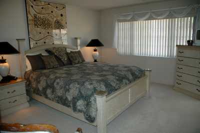 master bedroom w/ vaulted ceilings and two large closets