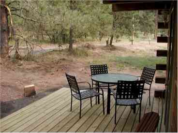 Looking toward the forest - a quiet spot to enjoy lunch, or stretch out on the chairs on the other portion of the porch and enjoy a good book!
You won't see the deer watching you!