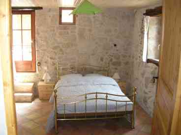 Showing the lovely white stone walls and handmade terrecuite floor tiles. This room has its own sitting out area.