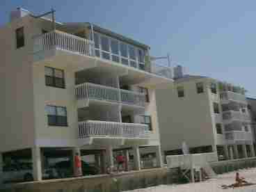 Gulf front unit 2BR/1BA, with large private balcony.  Close to town.  Beach chair, umbrella and jet ski rentals available on the beach.  Tiki bar next door, beach mart across the street! Sleeps 6