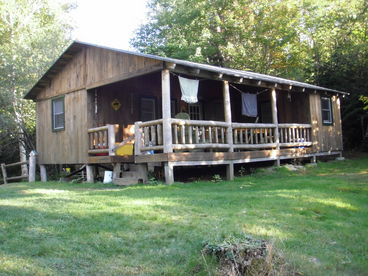 This cabin has a bedroom with a double down and a twin up.  Second sleeping area has twin bunks and another twin.  Gas stove, sink (hand carried water), living area, dining area, pots, pans, dinnerware are provided.  Propane heat. This cabin is all on one level.