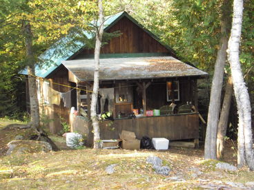This cabin has two downstairs bedrooms one with two sets of twin bunks, one with a double down and twin up.  Sleeping loft has a double and a twin.  Gas stove, sink (hand carried water), living area, dining area, pots, pans, dinnerware are provided.  Wood stove heat.