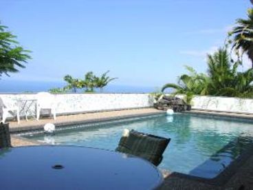 Huge blue pool facing Ocean View is on lanai surrounded by 4 bedrooms and kitchen area