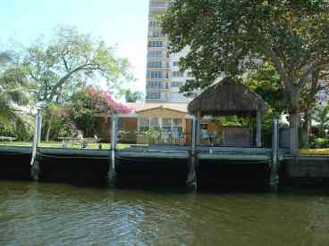 View of waterfront, back yard, dock and Tiki bar from the water