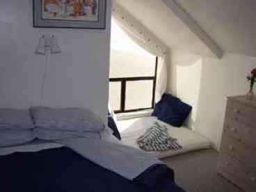 upstairs bedroom with ocean view from window seat