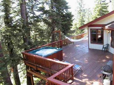 Step out from the billiard room to 2000 square feet of wrap around redwood deck, 8 person hot tub, BBQ grill, hammock, dining table and swivel rocker chairs beneath the tall trees of the Toiyabe National Forest.