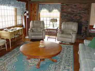Living room with cathedral ceiling and view of the harbor.