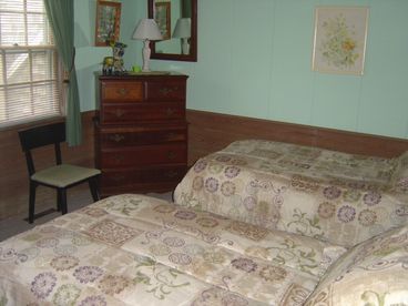 Bedroom with two twin beds, one dresser and large closet.