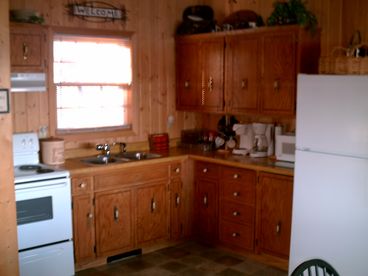 Old view of kitchen. Kitchen has been remodeled with all new cabinets and counter tops.