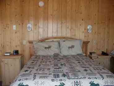 Master Bedroom with sliding glass door and  paneramic view of the lake. Beautiful, Beautiful, Beautiful. Also builtin desk area and closet armoire.