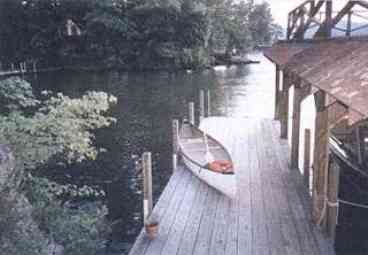 View of garden house and patio sitting area with slate walkway to the lake,boathouse and dock.
