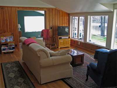 The great room has large windows overlooking the water and skylights to ensure the interior is bright and cheery.