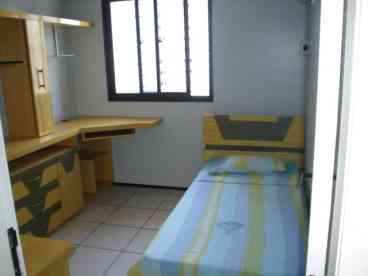 twin size bed with closet, desk, individual A/C unit and bathroom 