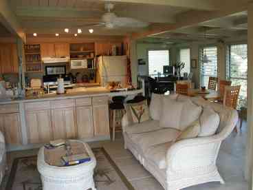 LIving room with open kitchen and computer area