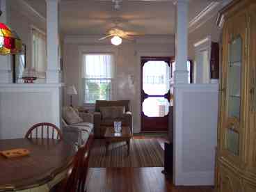 AWESOME FRONT PORCH W/ DINING TABLE @ 6 AND CUSHIONED SEATING @ 6