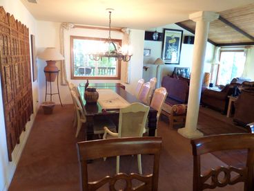 View of the dining are from the breakfast bar at the kitchen. Beyond the window/wall is the entry into the living room