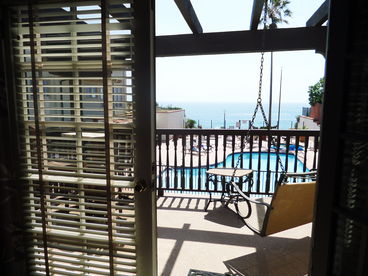 Looking out from the Master Bedroom, this is the view across the pool to the Oceanfront. Enjoy coffee, or enjoy sunsets from the King Master Bed