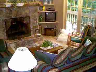 With cathedral ceiling and clerestory windows, the living room feels cozy with a fire in the wood burning fireplace.  With cable tv, VCR, cd/cassette player, books, a small assortment of videos and cd/s, guests can be entertained or just enjoy the quiet.