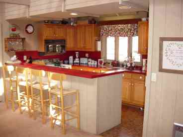 The kitchen is well equipped with oven, microwave, dishwasher, full size refrigerator with ice maker, garbage disposal, sharp knives, quality pots and pans, pretty dishes, electric griddle and everything from a grapefruit knife to a crock pot.