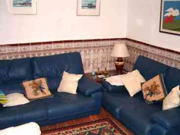 Lounge area: Good-sized room furnished with two leather sofas, two armchairs, coffee table, colour TV with English satellite channels and video player and air conditioning / heating unit. 

