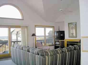 Upper Level Greatroom with nice Ocean Views and seating area. This room also features a fireplace and is open to the dining and kitchen areas.