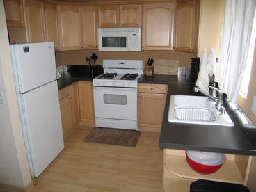 Full kitchen includes microwave, dishwasher, coffee maker, plates, glasses, flatware, serving pieces, normal appliances
