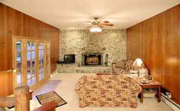 Family Room with Natural Stone Open Fireplace, Wood Provided.There is a Living Room Also, not shown, to make two spacious living areas.