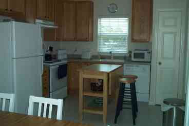 Fully-equipped modern kitchen features dishwasher, microwave, coffee maker, toaster, blender, food processor, and more!