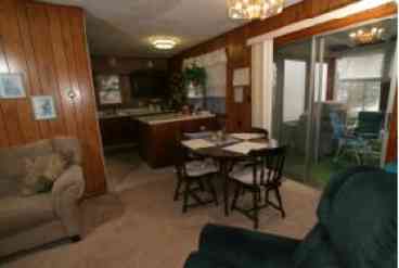 Dining area with entry to sun room and kitchen area from the living room.