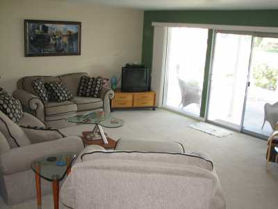 Living room with views of mountains and fairway.