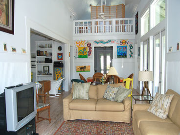 The LIVING ROOM has a 20\' vaulted ceiling and is open to the kitchen, dining room, and sitting alcove.