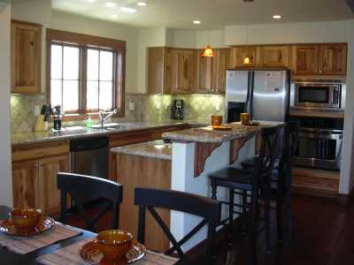 Gourmet Kitchen with Granite Slab and Pine Plank Flooring!