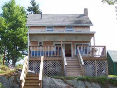 View of cottage and porch from water