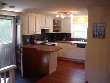 Natural slate details with Oak Trim, Fully outfitted kitchen and BBQ deck. Two full size refrigerators with an ice maker. Two dishwashers and ranges, Washer Dyer too!