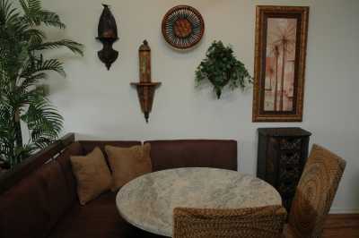 7 people can sit at this corner unit with granite table top and cooled by  ceiling fan.