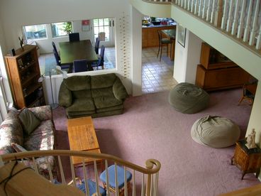 An overview of the living area, looking into the family room/eating area.  Formal dining room on the right.