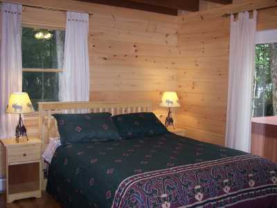 One of the master bedrooms over looking the lake. French door open to the hot tub that is on the porch.