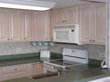 The kitchen is complete with full size appliances, blender, toaster, coffee maker, cookware, dinnerware, and flatware.