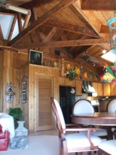This house offers a completely Cedar interior with 17 foot Dade County Pine ceiling throughout. The open and airy dining area, kitchen and family room have beautiful tropical furnishing has a circular stairway to lower level. The upper level bedrooms and full bathrooms are large and also have cedar beamed ceiling throughout.