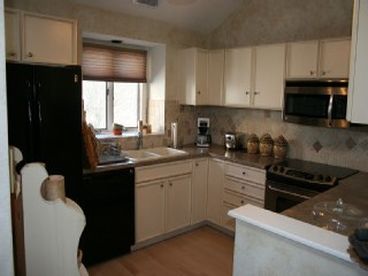 The kitchen has all new appliances and tile work.