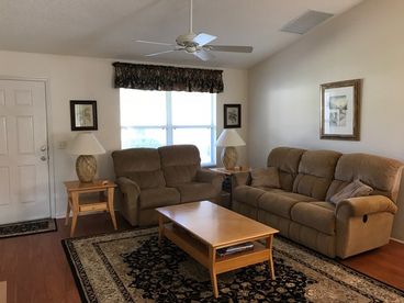 Spacious living room with recliner sofas and large screen HDTV